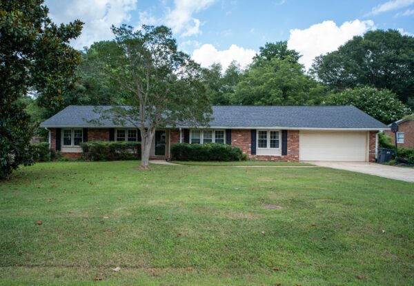 Exterior view of a modern house in Greenville, SC, with a landscaped front yard