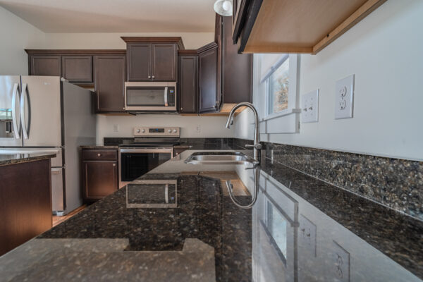 Gourmet kitchen in Travelers Rest, SC, featuring stainless steel appliances and granite countertops