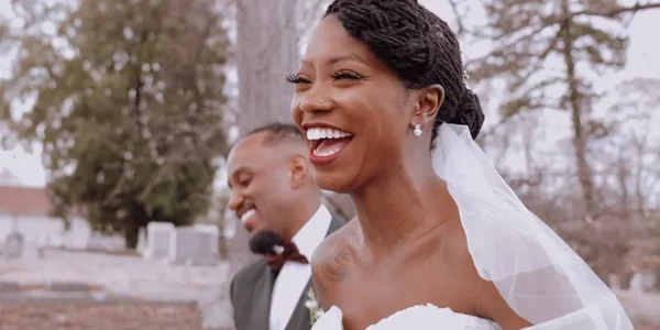 Bride Keke with groom Lucas, laughing.