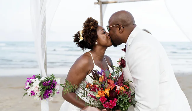 Bride and Groom kissing at a beach wedding